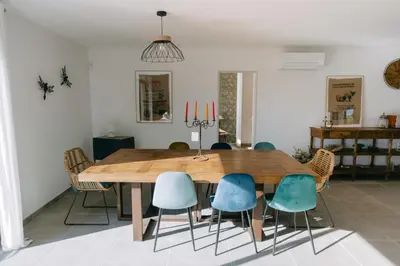 a dining room with a wooden table and chairs at La Dolce Vita Provençale Charming House with its Private Swimming Pool in LʼIsle-sur-la-Sorgue