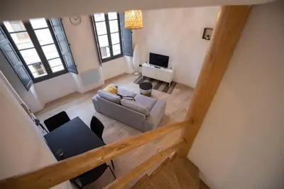 an overhead view of a living room with a couch and a tv at Le Duplex - Hypercentre - Wifi in Carpentras