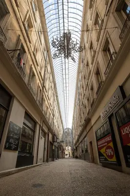 an empty hallway in a building with a ceiling at Le Duplex - Hypercentre - Wifi in Carpentras