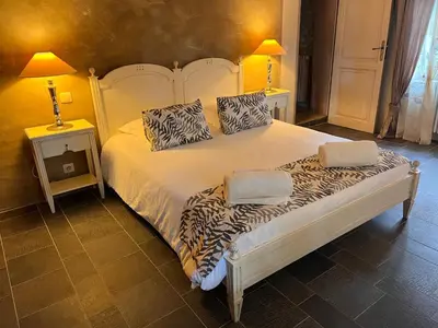 a bed with two pillows on it in a room at La Petite Paradisse – mas provençal exceptionnel in Blauvac