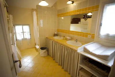 a bathroom with two sinks and a mirror at La Petite Paradisse – mas provençal exceptionnel in Blauvac