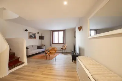 a living room with a couch and a table at L'antiquaire - 3 chambres - Hypercentre - Wifi in LʼIsle-sur-la-Sorgue