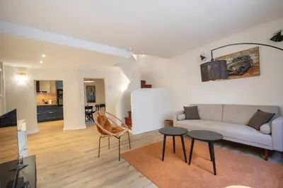 a living room with a couch and two tables at L'antiquaire - 3 chambres - Hypercentre - Wifi in LʼIsle-sur-la-Sorgue