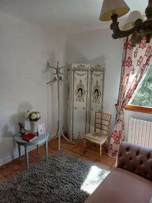 a living room with a couch and a table at Chambre d'hôte suite Tournesol 