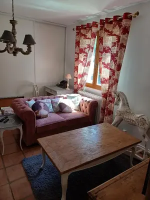 a living room with a couch and a table at Chambre d'hôte suite Tournesol 