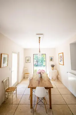 a dining room with a wooden table and chairs at Villa des Alpilles in Eygalières