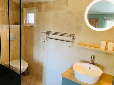 a bathroom with a sink and a toilet and a mirror at La Belle Lumière in Saint-Saturnin-les-Apt