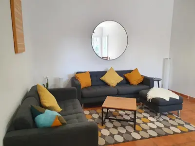 a living room with a couch and a mirror at Villa Tassigny in Aix-en-Provence