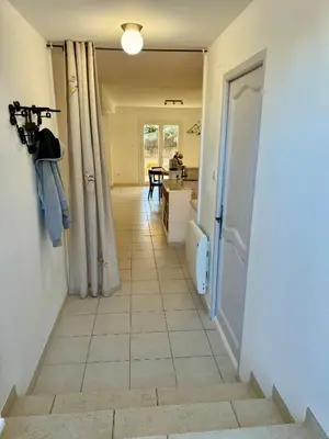 a hallway with a bathroom with a toilet and a door at Les 2 Oliviers in Caromb