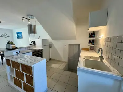 a kitchen with a sink and a counter top at Les 2 Oliviers in Caromb