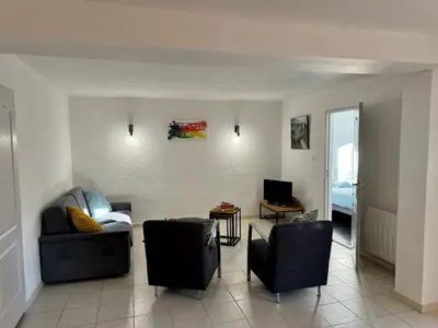 a living room with two chairs and a couch at Les 2 Oliviers in Caromb