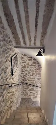 a room with a stone wall and a ceiling with a light at Latipik in Lançon-Provence