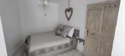 a bedroom with a bed and a wooden door at Latipik in Lançon-Provence