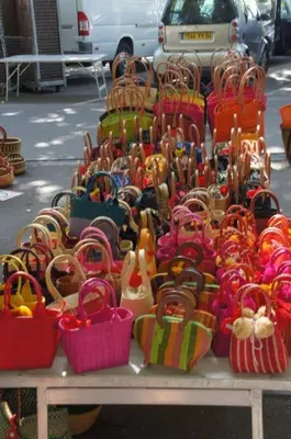 a display of purses and baskets on a table at Masmazan in Mazan