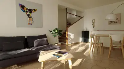 a living room with a couch and a table at Lovely house teracce and parking in historic center in Aix-en-Provence