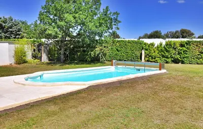 a swimming pool in the middle of a yard at La Villa Des Songes in Pernes-les-Fontaines