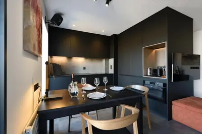 a dining room with a table and chairs in a kitchen at Aix Rooftop Appartement T2 Luxe 5 étoiles - hypercentre Rotonde - Terrasse - Vue - Parking in Aix-en-Provence