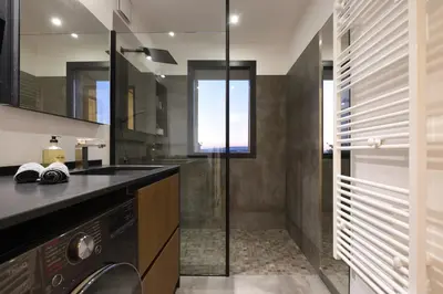 a bathroom with a sink and a washing machine at Aix Rooftop Appartement T2 Luxe 5 étoiles - hypercentre Rotonde - Terrasse - Vue - Parking in Aix-en-Provence