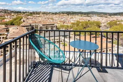 a table and a chair on a balcony with a view at Aix Rooftop Appartement T2 Luxe 5 étoiles - hypercentre Rotonde - Terrasse - Vue - Parking in Aix-en-Provence