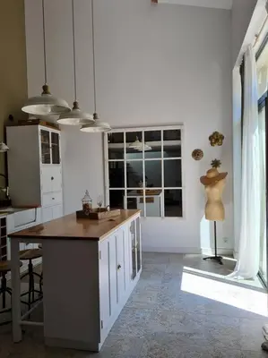 a kitchen with a island in the middle of a room at Le Mas du Castellas 5* in Le Thor