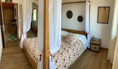 a bedroom with a bed with curtains on it at Domaine des Lavarines in Morières-lès-Avignon