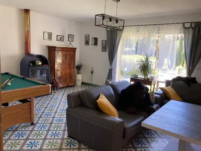 a living room with a couch with a teddy bear laying on it at Domaine des Lavarines in Morières-lès-Avignon