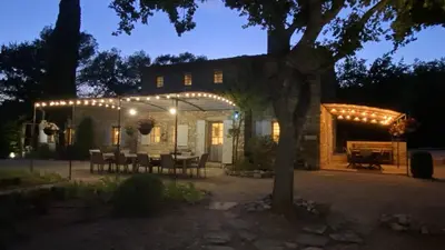 a house with a pergola with lights on it at Mas de Veroncle, piscine et quiétude à Gordes in Gordes