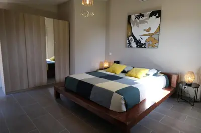a bedroom with a bed and a painting on the wall at Provençal farmhouse, Mont Ventoux view, 2 pools (1 heated), Bédoin - 10 people in Bédoin