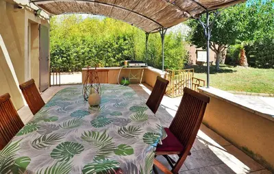 a table and chairs sitting on a patio at Zèbre in Eyragues