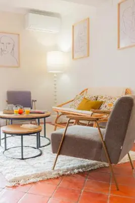 a living room with a couch and a table at Deux chambres avec terrasse dans le centre ville d'Aix en Provence in Aix-en-Provence