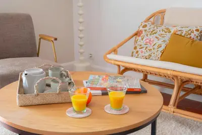 a coffee table with two glasses of orange juice at Deux chambres avec terrasse dans le centre ville d'Aix en Provence in Aix-en-Provence