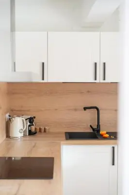 a kitchen with white cabinets and a sink at Deux chambres avec terrasse dans le centre ville d'Aix en Provence in Aix-en-Provence