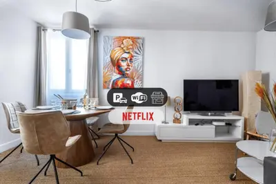 a living room with a table and a tv at CŒUR DU VENTOUX Carpentras Bel appart 6 places in Carpentras