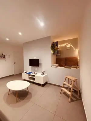 a small living room with a table and a stool at Appartement neuf Bédoin - Les Cinglés du Mont Ventoux in Mormoiron