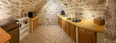a small kitchen with a sink and a microwave at LA BASTIDETTE PROVENçALE in Jouques