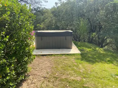 a small shed sitting on a platform in a yard at LA BASTIDETTE PROVENçALE in Jouques