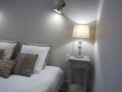 a bedroom with a bed and a lamp on a table at Le mas de Roussillon in Roussillon