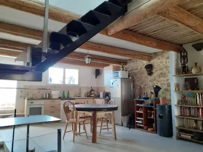 a kitchen with a table and chairs in a room at Maison restaurée à l'ancienne avec terrasse in Jouques