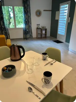 a table with a tea kettle and glasses on it at Appartement cosy in Aix-en-Provence