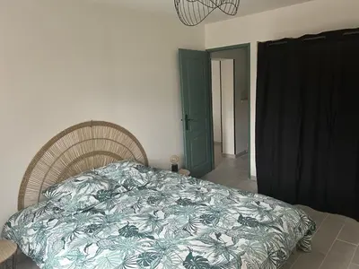 a bedroom with a bed with a blanket on it at Appartement cosy in Aix-en-Provence