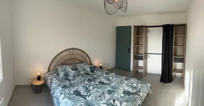 a bedroom with a bed and two candles on the floor at Appartement cosy in Aix-en-Provence