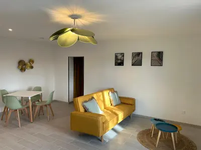 a living room with a couch and a table at Appartement cosy in Aix-en-Provence