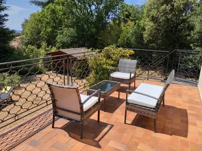 three chairs and a table on a patio at Maison avec piscine chauffée, centre village in Saint-Saturnin-les-Apt
