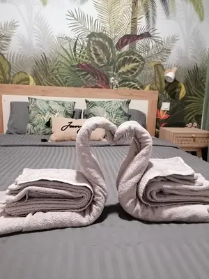 two towels shaped like swans sitting on a bed at Escapades L'Isloises au cœur de L'Isle-sur-la-Sorgue. in LʼIsle-sur-la-Sorgue