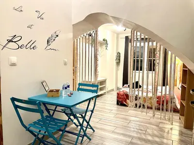a dining room with a blue table and chairs at *Le Lotus*Fiber Wifi*Hyper Center* in Salon-de-Provence