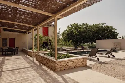 an outdoor patio with chairs and a table at La ferme du 645 in Entraigues-sur-la-Sorgue
