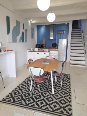 a kitchen and dining room with a table and chairs at L'atelier au coeur du village in Roussillon