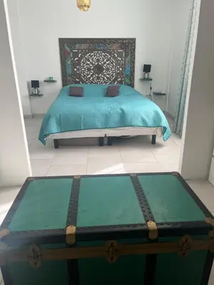 a bedroom with a bed with a turquoise bed sidx sidx sidx at House of Essia in Aix-en-Provence