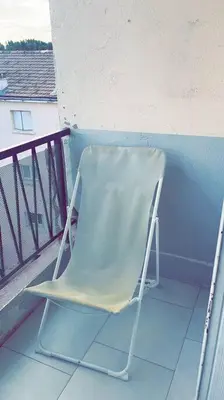 a green chair sitting on a balcony at House of Essia in Aix-en-Provence