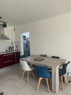 a wooden table in a kitchen with chairs around it at House of Essia in Aix-en-Provence